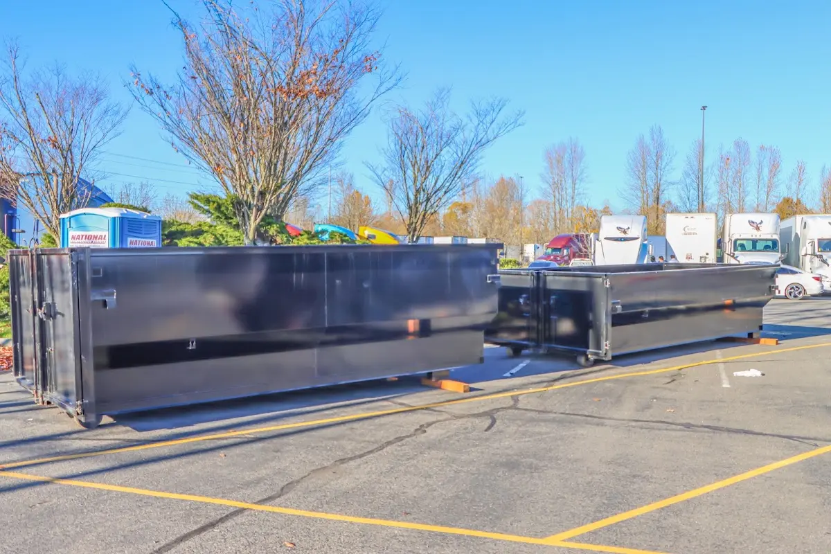 Professional dumpster rental service with roll-off container on residential driveway in Lake Geneva